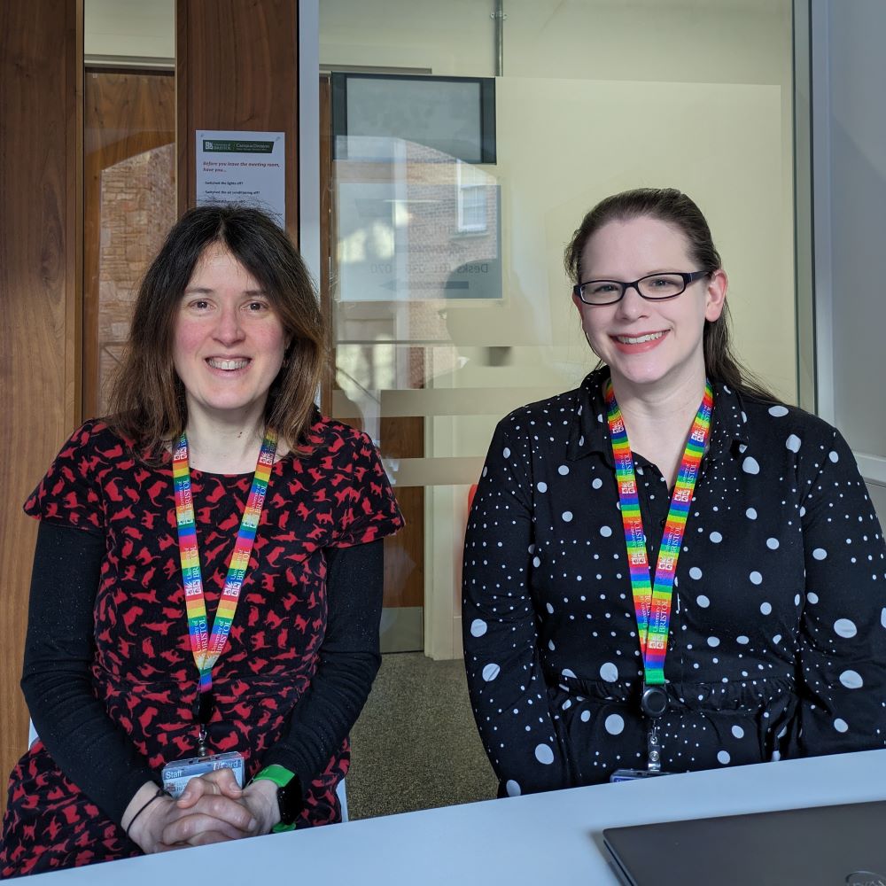 Two members from the meta data team sitting at a desk.